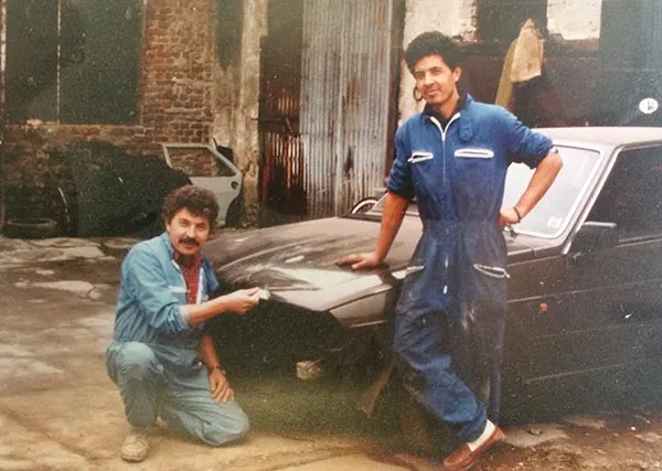 Foto d’archivio della carrozzeria: due carrozzieri accanto a un’auto